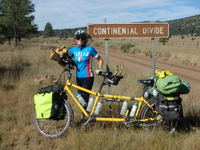 GDMBR: Terry Struck and the Bee (da Vinci Touring Tandem) posing in front of a Continental Divide Sign, literally on the Continental Divide Trail (CDT) at the GDMBR's Divide Crossing #24.